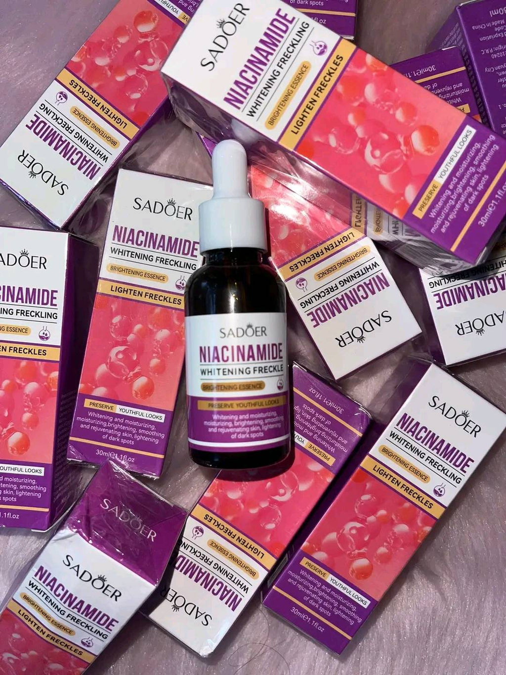 Sador niacinamide skincare product with packaging on a wooden surface
