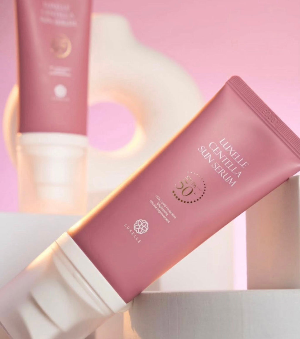 Pink skincare serum tube with brand name on a soft pink background