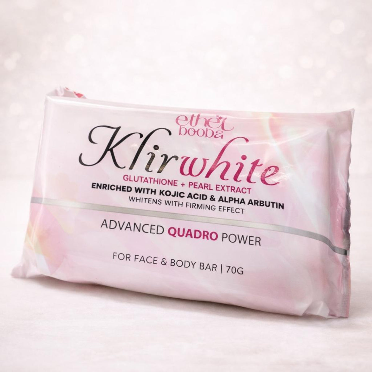 A 70g bar of Ethel Boodea Khirwhite Advanced Quadro Power face and body soap, shown in its pink and white packaging against a soft, light bokeh background.