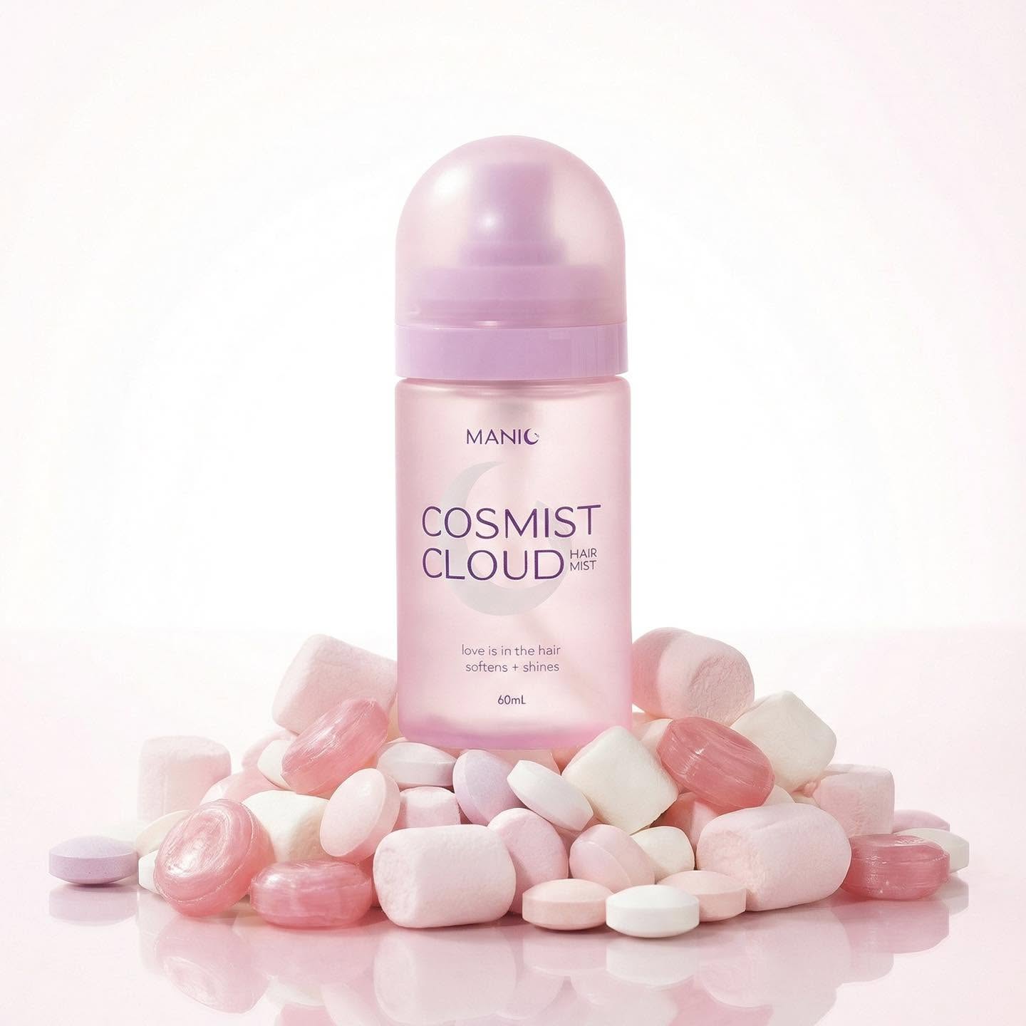 MANIC Cosmist Cloud hair growth serum bottle in pastel pink, surrounded by pink and white capsules on a clean white background.