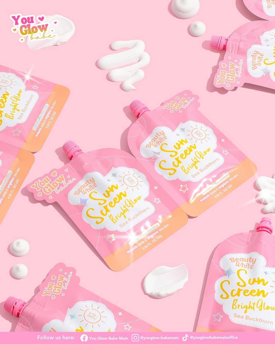 Sunscreen bottles with 'You Glow Babe' branding on a pink background