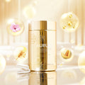 Gold skincare bottle labeled 'AURUM' with decorative elements on a reflective surface.