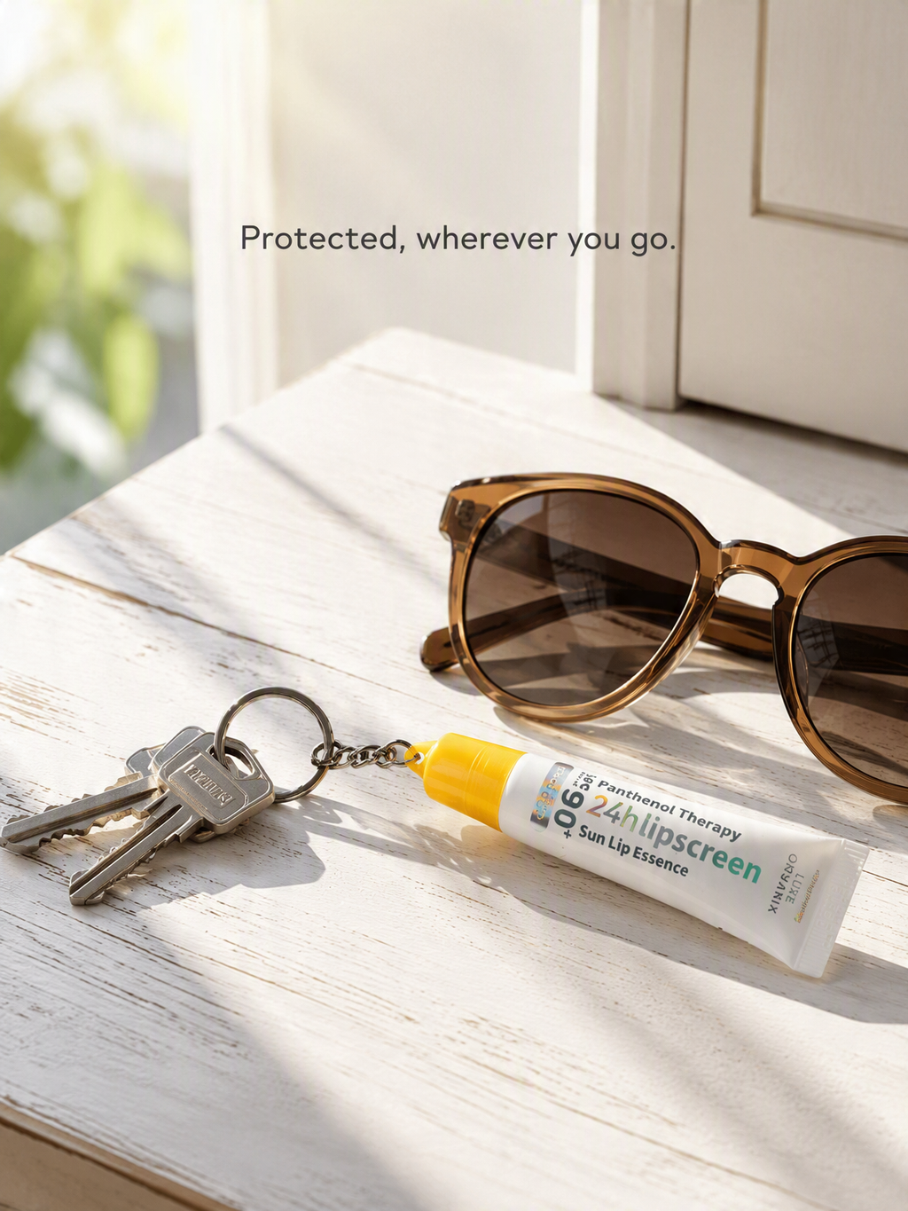 A tube of Q35 sunscreen lip essence with a yellow cap lies on a white wooden table next to sunglasses, keys, and a door, with the text 'Protected, wherever you go.'.