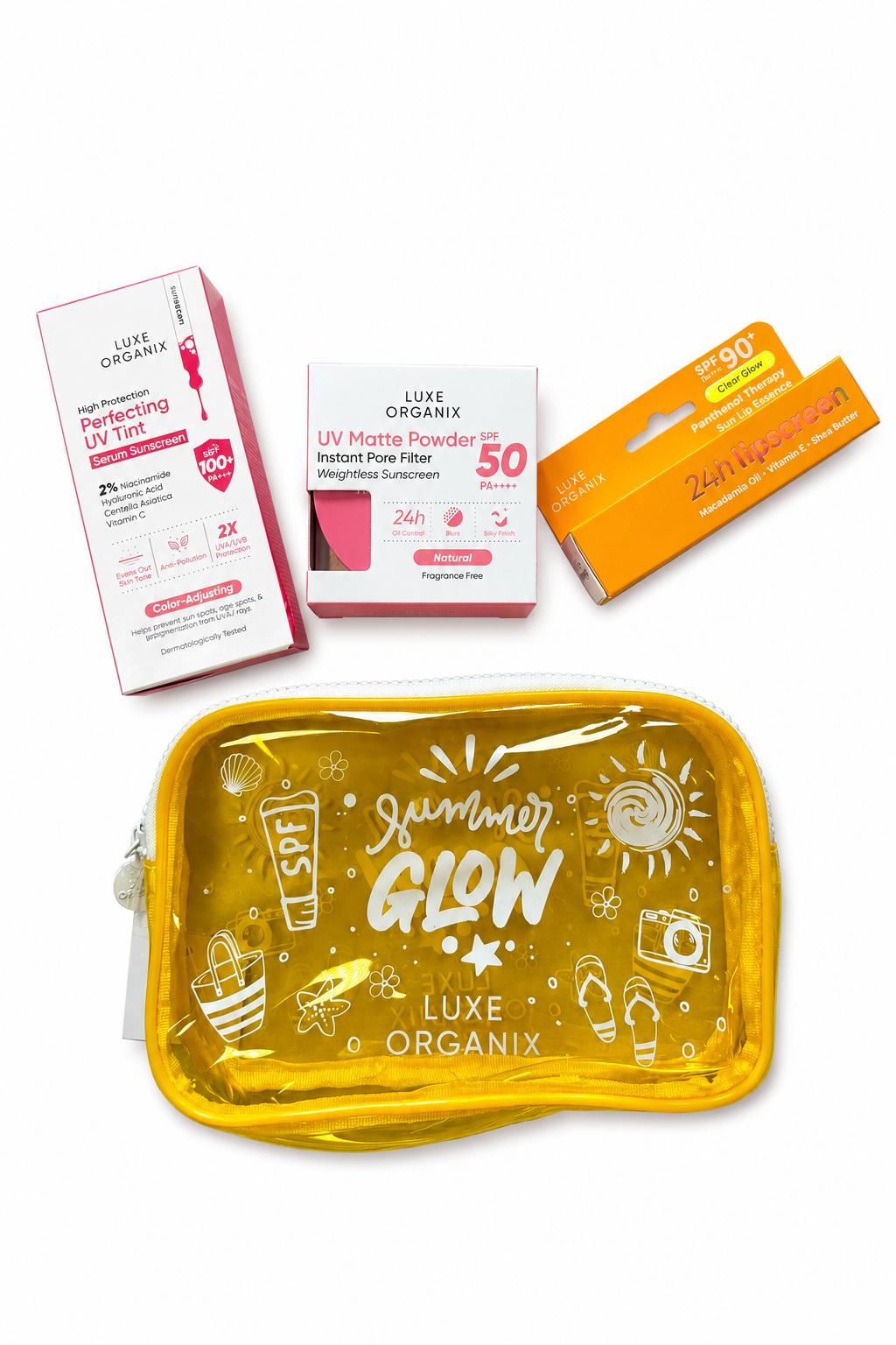 A set of Luxe Organix sunscreen products arranged on a white background, including a large yellow translucent pouch with 'Summer Glow' printed on it, along with pink and orange boxes and tubes of sunscreen.