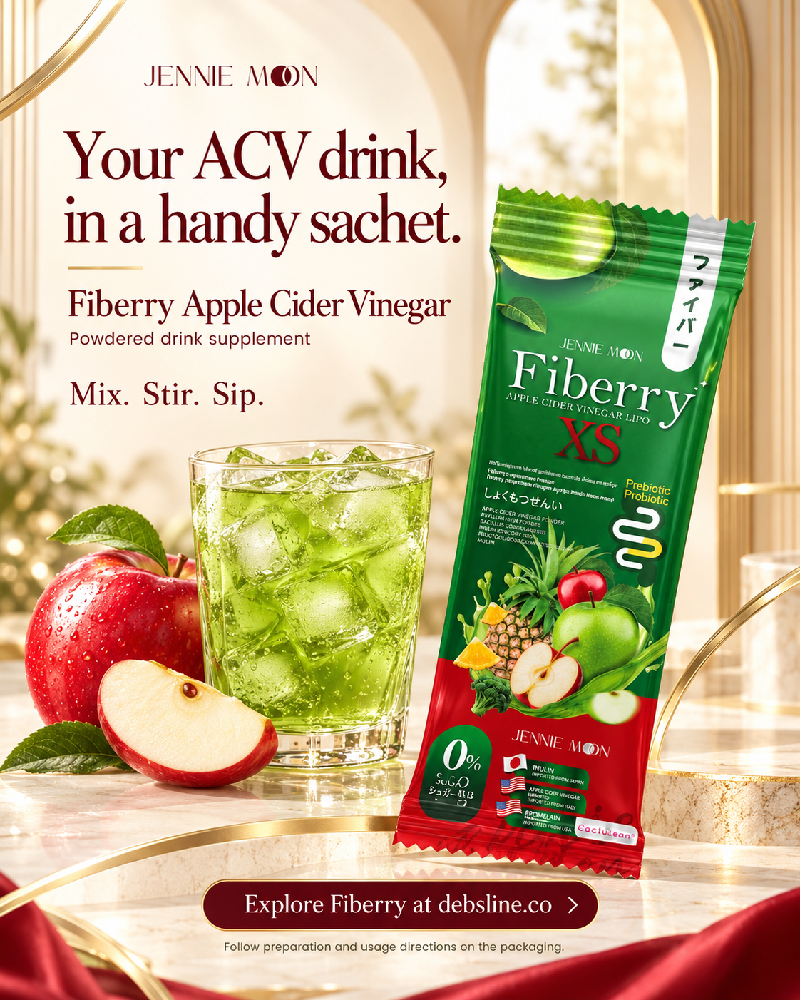 Jennie Moon Fiberry XS Apple Cider Vinegar powder sachet shown next to a glass of green iced drink, with red apples and a marble background. Text on the image reads 'Your ACV drink, in a handy sachet.