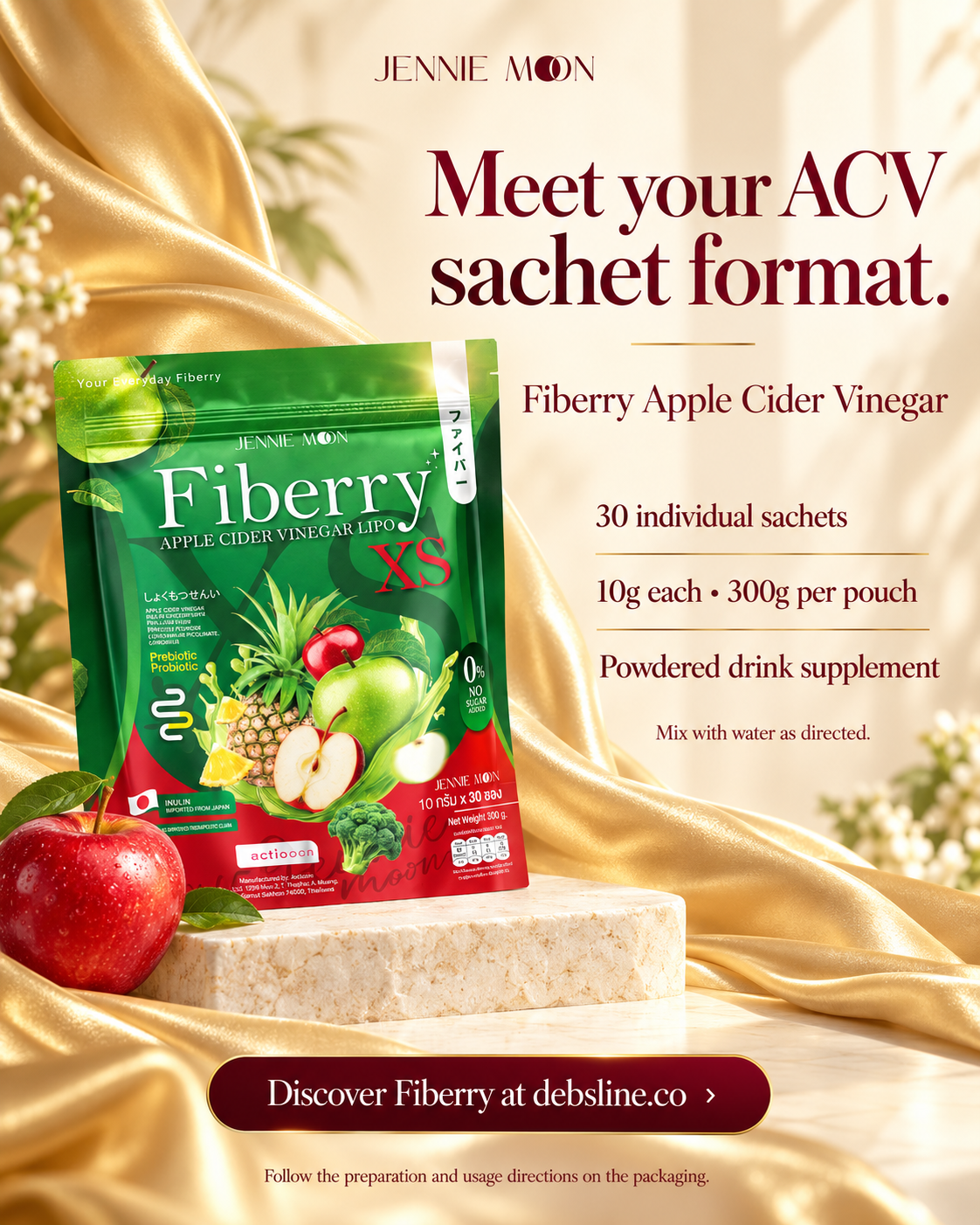 Jennie Mon Fiberry Apple Cider Vinegar sachet package shown on a luxurious gold satin background with a red apple prop. The ad text highlights the ACV sachet format, 30 individual sachets, 10g each, and 300g per pouch.