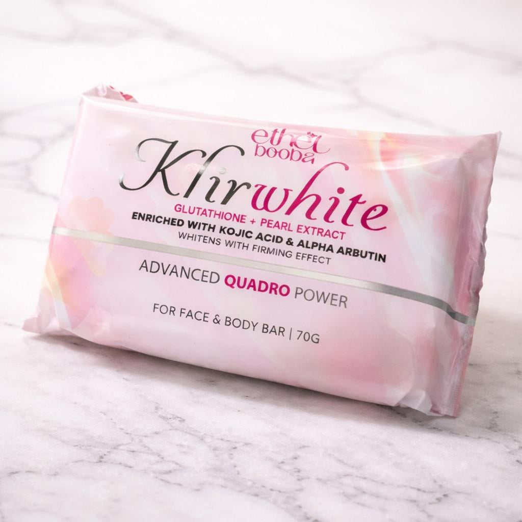 A pink foil-wrapped bar of body and face soap from Elixir Dooda, labeled 'Kirwhite Advanced Quadro Power', resting on a white marble surface.